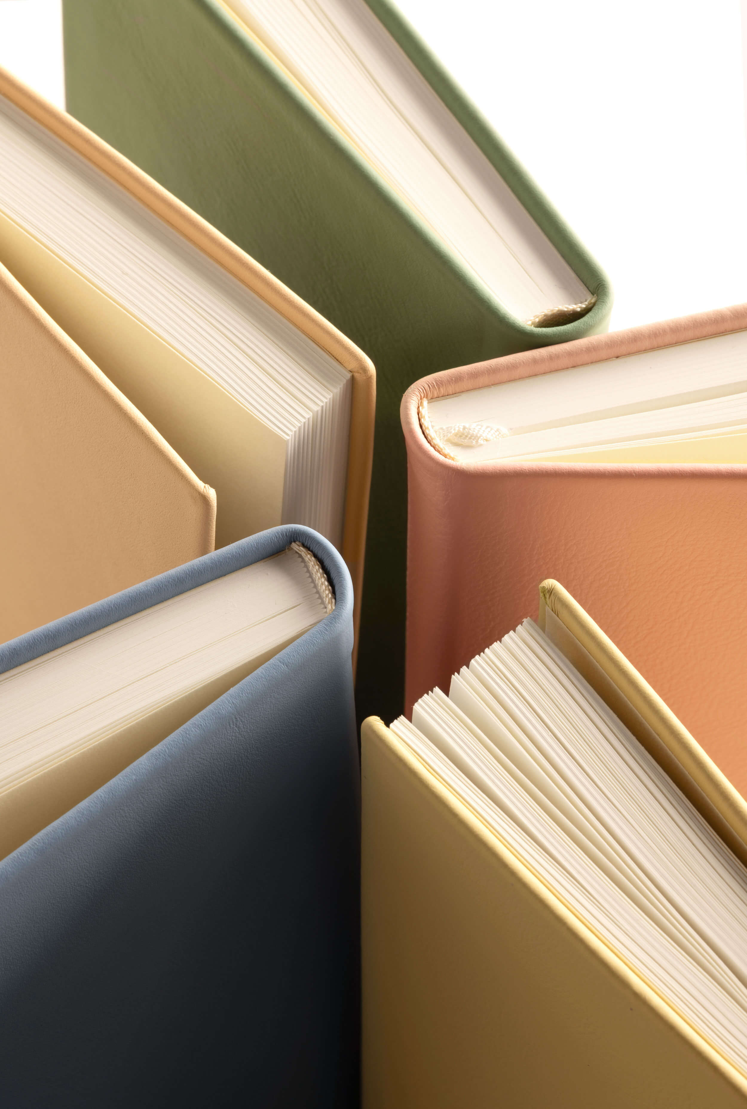 Close-up of binding on Monsieur et Madame Heritage Collection notebooks, pastel sustainable Italian leather—London luxury stationery for mindful writing.