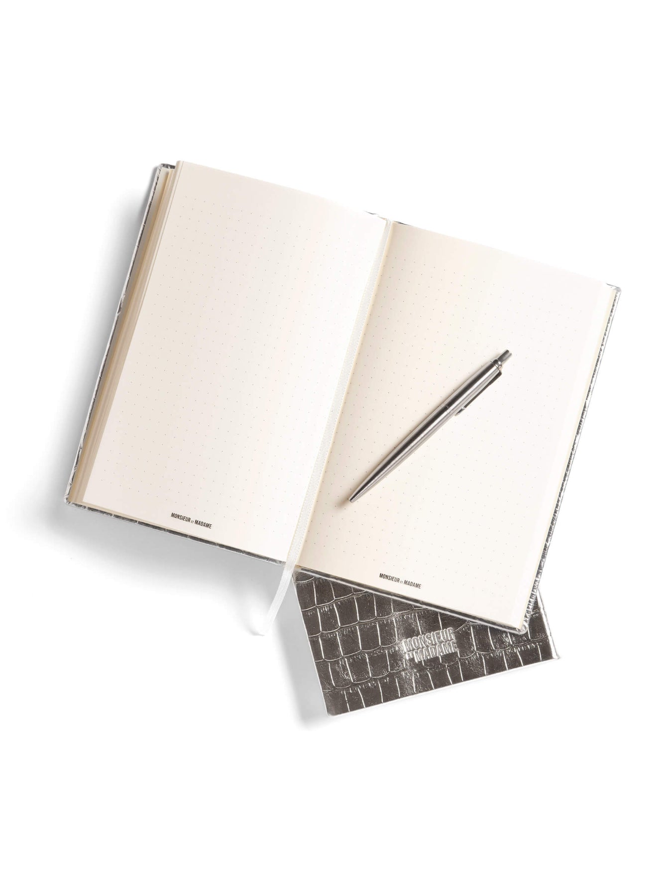 Open notebook with a pen on top, on a white background